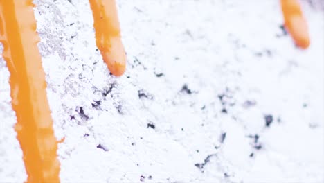 orange paint drips on a white wall