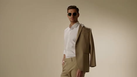 stylish man in beige suit and sunglasses
