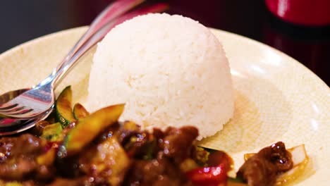 sizzling beef and vegetables served with steamed rice