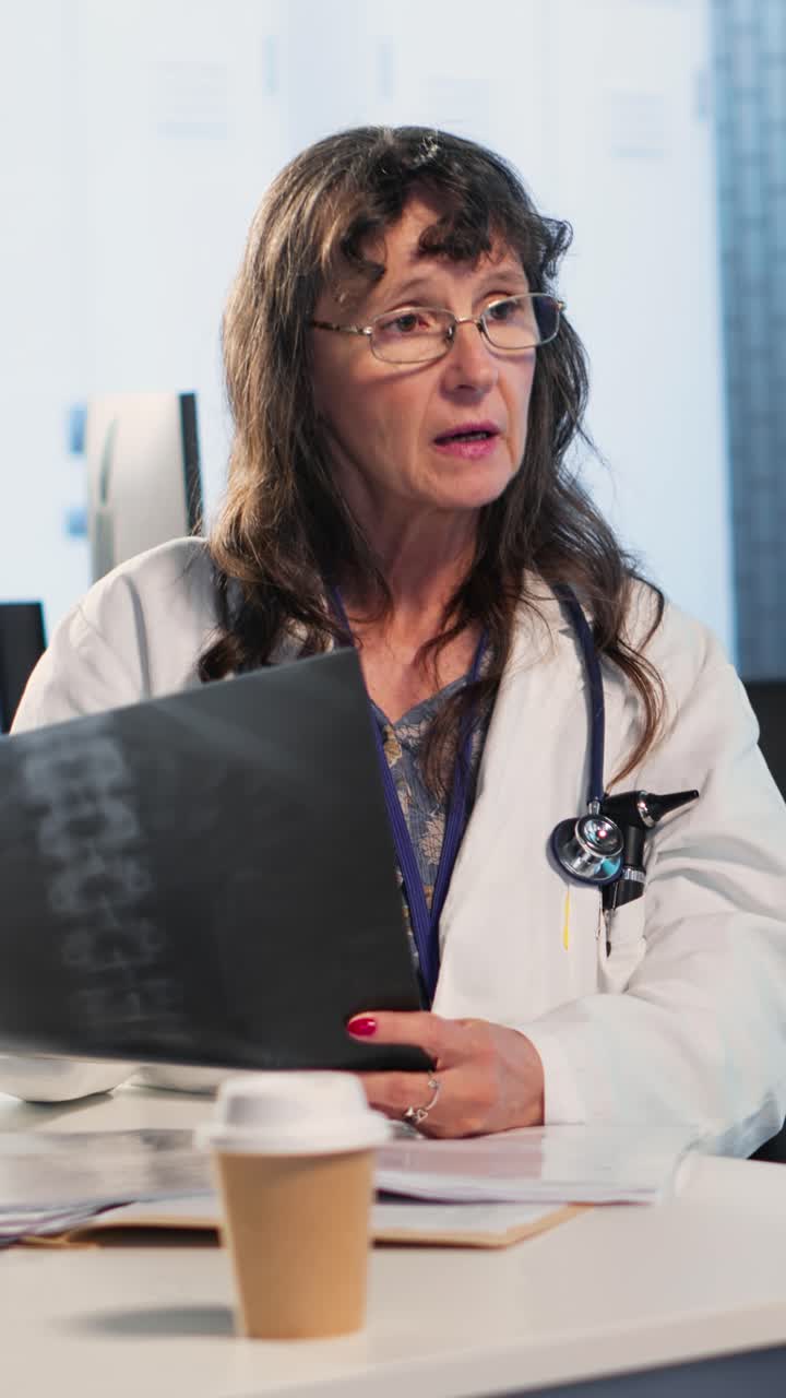 Vertical Video Woman medic presenting diagnostic report to wheelchair user during consultation