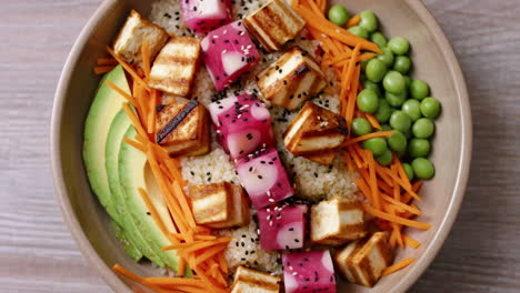 healthy plant-based grain bowl with tofu and vegetables