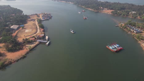 aerial view of a boat yard in mangaluru that is close to the sultan bathery ferry service, with the sun reflected in the backwaters