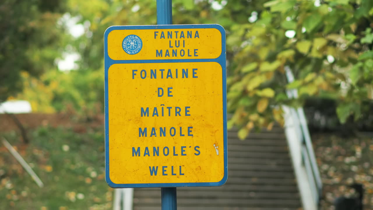 TRANSFAGARASAN, ROMANIA - OCTOBER 10, 2021: Manoles well sign on a post in Curtea de Arges, Romania