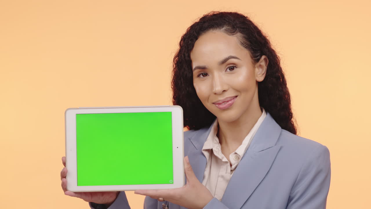 Woman holding tablet with green screen
