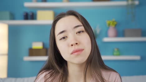 Close-up-portrait-of-young-Asian-woman-feeling-tired-and-exhausted-at-home.