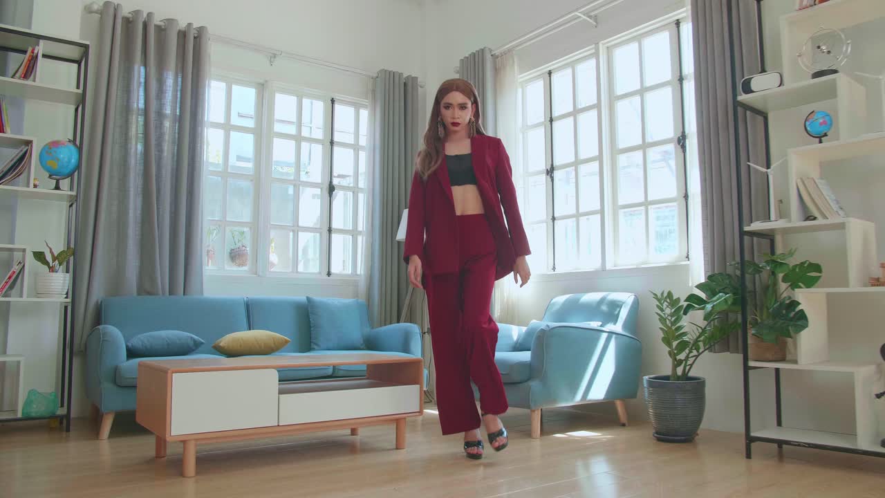 Young Fashion Transgender Woman Wearing Red Clothes Walking And Posing In Home