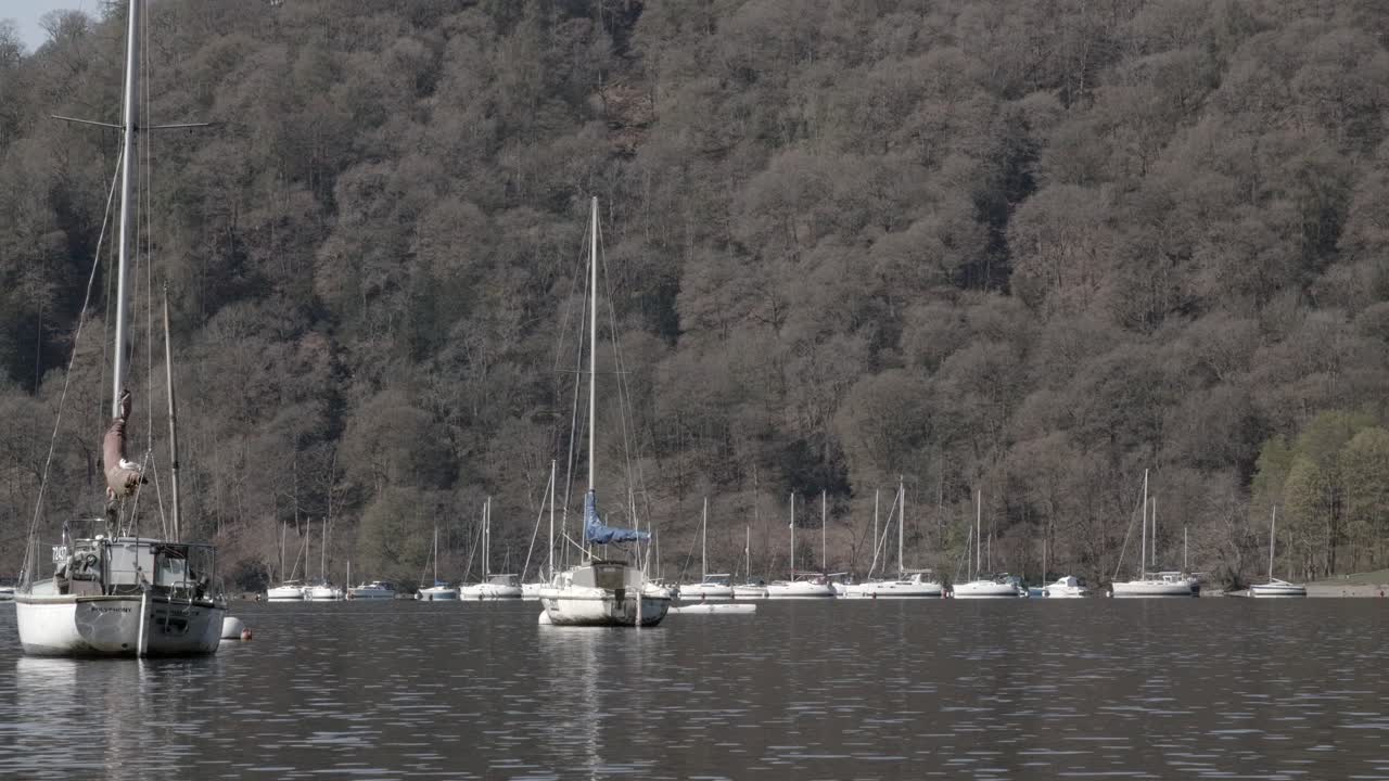 Sailboats Moored on a Calm Lake with Kayakers