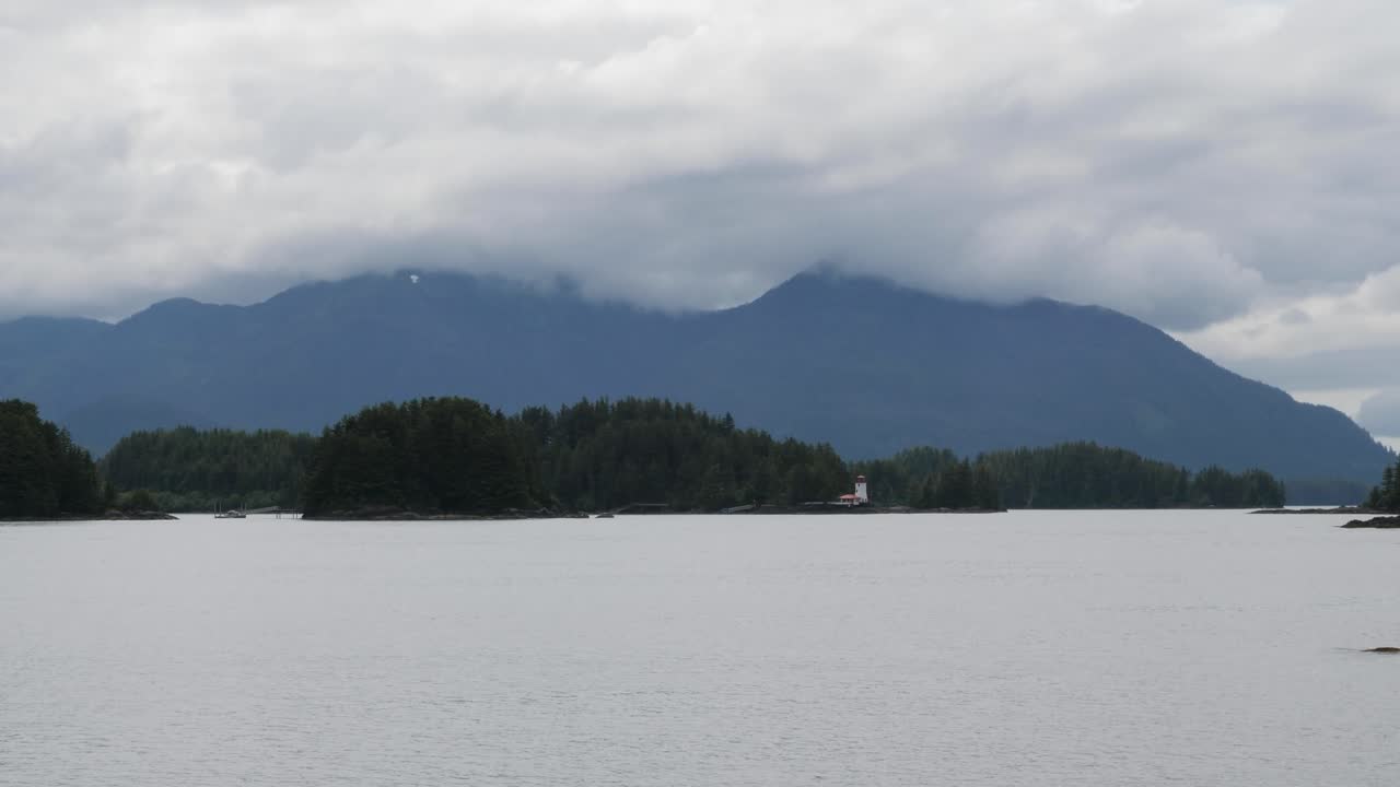 Sitka Lighthouse, Galankin Island, Alaska.Mount Kinkaid covered by clouds.