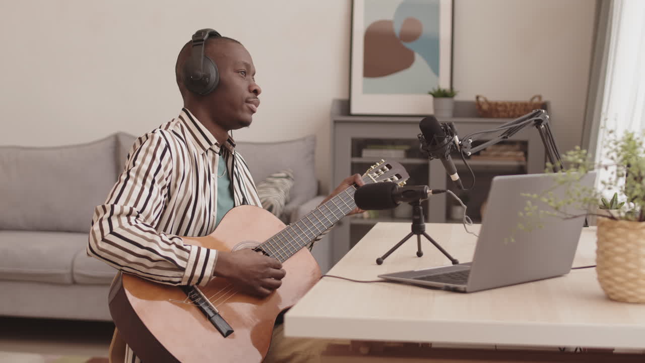 Man playing guitar and recording podcast