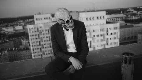 person in skull mask on rooftop