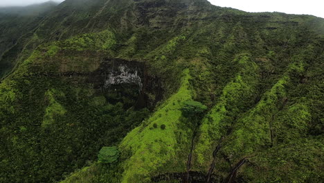 aerial view of lush mountain valley with waterfall