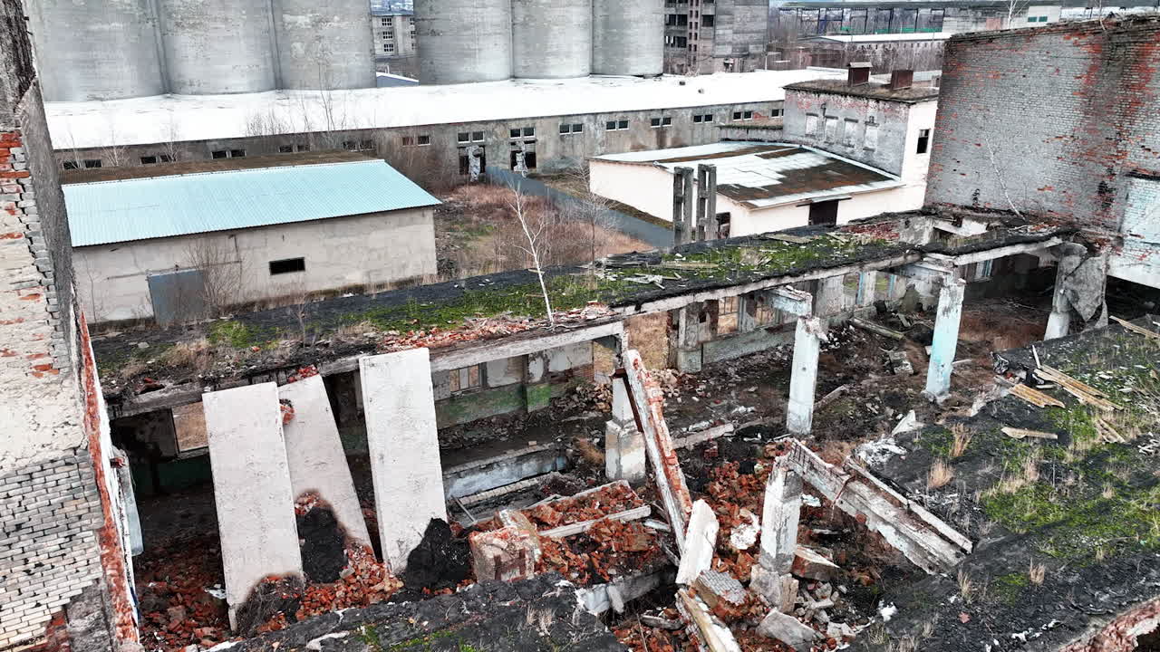 Devastated territory with ruins and wrecks at wartime. Aerial perspective on debris left after the bombing.