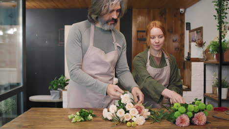 florists arranging flowers in bouquet