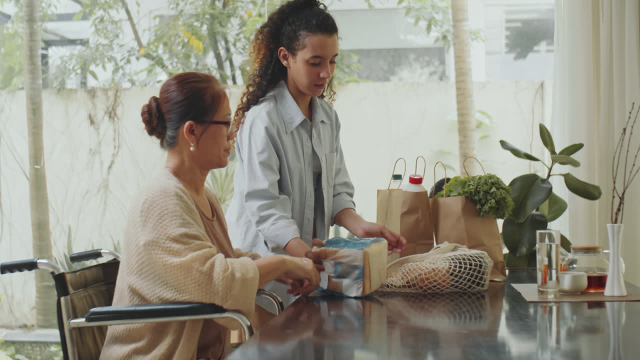 Senior Woman Receiving Groceries from Caregiver