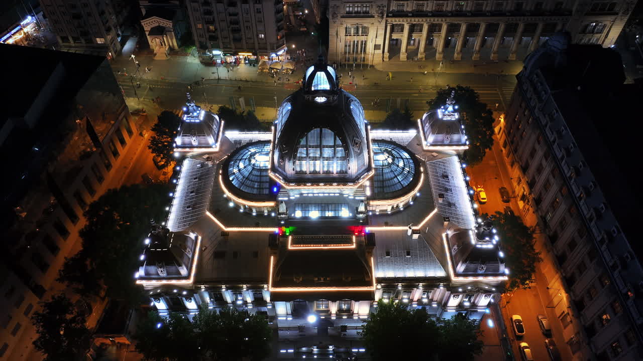 Aerial drone view of the Palace of the Deposits and Consignments illuminated in Bucharest, Romania at night