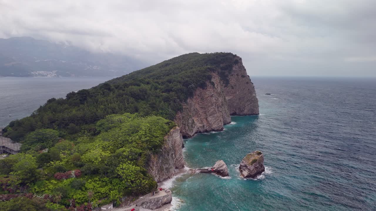 Aerial to Adriatic sea cliffs of Sveti Nikola island, Budva Montenegro