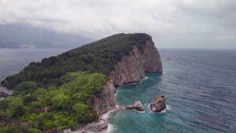 aerial to adriatic sea cliffs of sveti nikola island, budva montenegro