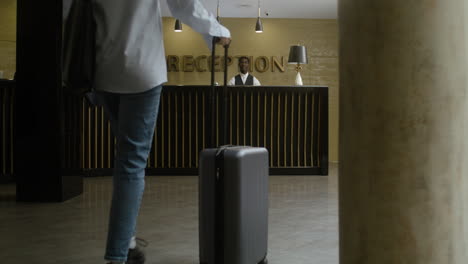 guests approaching the hotel reception desk