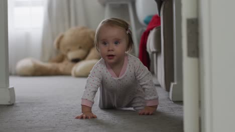 close up of caucasian baby crawling on the floor at home