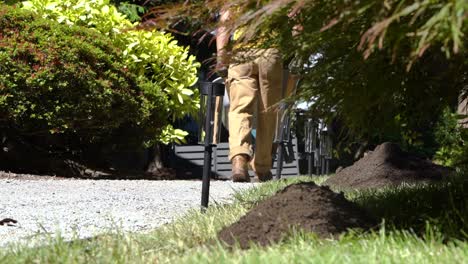 man pushing a wheelbarrow full of dirt - slow motion