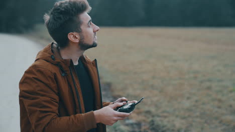 young man flying a drone outside