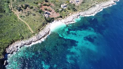 top view of a beautiful white sandy bay with crystal clear turquoise water (zingaro on the island of sicily in italy), very nice and sunny weather