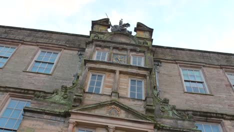 looking up at north front of mansion house at lyme park in cheshire, england