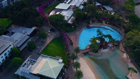 Pan-up-Aerial-view-Of-South-Bank-parklands-with-empty-swimming-pools-during-sunset-during-Covid19-pandemic