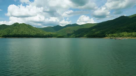 4k cinematic nature aerial footage of a drone flying over the beautiful lake and mountains of srilanna national park in chiang mai, thailand on a sunny day