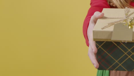 Close-Up-Festive-Girl-Holding-Christmas-Present-with-Copy-Space