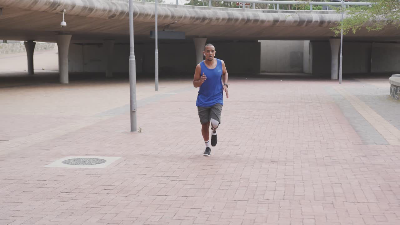 Front view man with prosthetic leg running