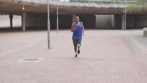 front view man with prosthetic leg running