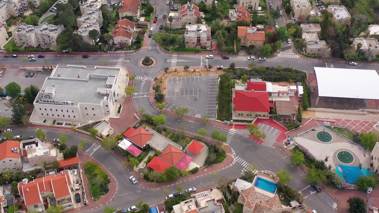 Aerial view of a residential neighborhood with houses, roads, and a roundabout