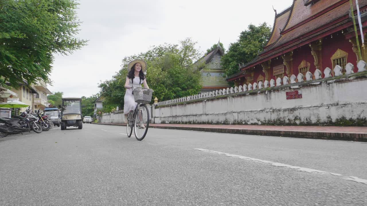 Beautiful Asian Girl Cycling To Visit Luang Prabang, Slow Motion