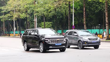 cars and motorbikes navigate a bustling street