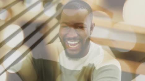 smiling man with bokeh lights in background