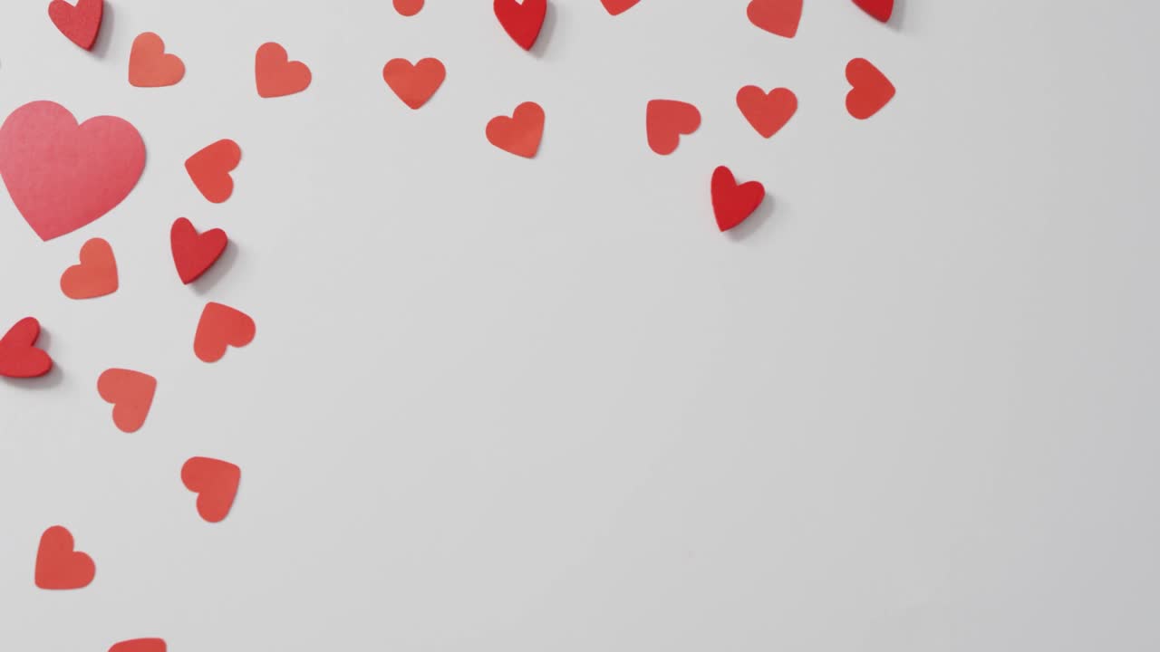Red paper hearts on pink background at valentine's day