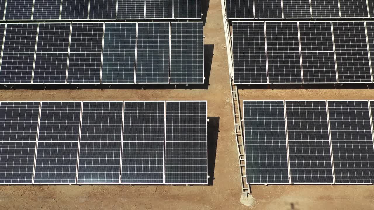 drone view of solar panels stand in a row in the fields power ecology innovation.4k video