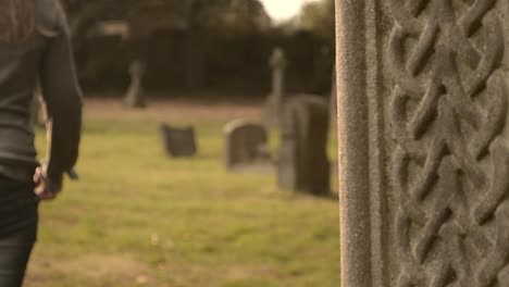 Woman-walks-through-graveyard