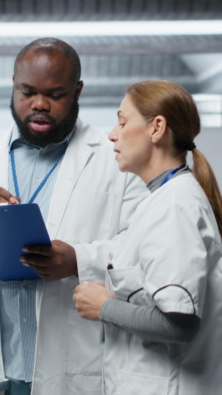 Vertical Video Medical researchers performing clinical evaluation of a patient in a laboratory