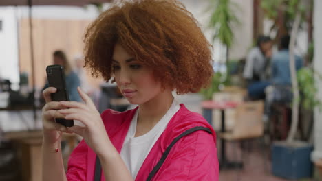 portrait of cute young woman taking photo using smartphone mobile camera technology in urban restuarant background