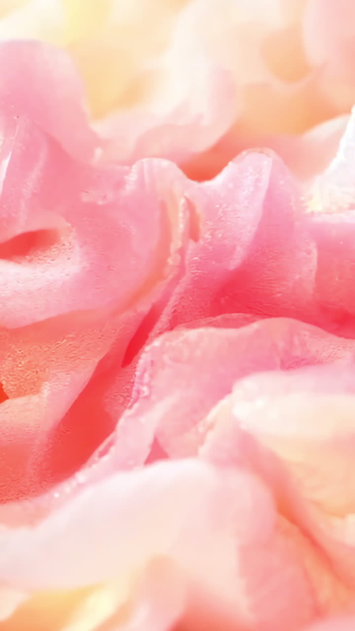 A pink and yellow fabric with a wave pattern. The colors are bright and the fabric appears to be made of a synthetic material. The wave pattern gives the fabric a sense of movement and energy