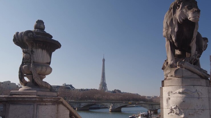 Lion Statue On Pont Alexandre III with Eiffel Tower In The Background In Paris, France. - tilt down