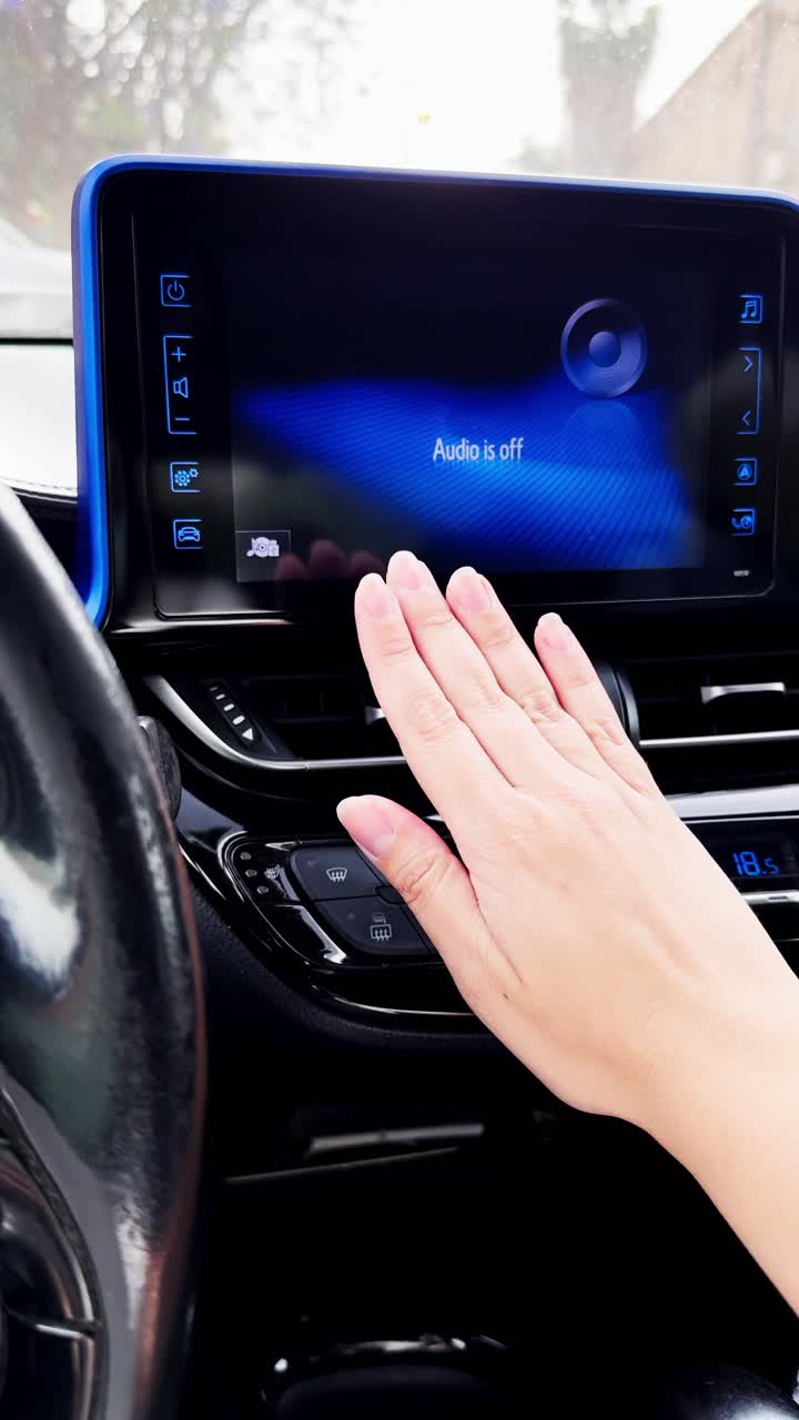 A person is adjusting the temperature in a car