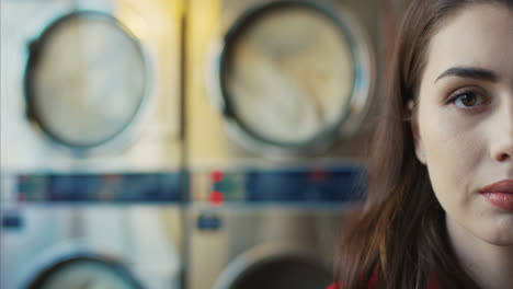 close up of half face of young pretty stylish woman with red lips and in yellow glasses smiling to camera in laundry service room 2