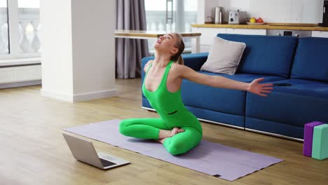 woman in sportswear talk on video call performing pranayama exercise