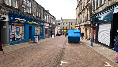 people walking along a vibrant shopping street