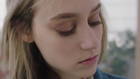 close-up-portrait-of-beautiful-young-blonde-woman-looking-at-camera-femine-vulnerable-running-hand-through-hair-caucasian-female-perfect-skin