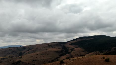 aerial drone hyper lapse mountain range and rain clouds