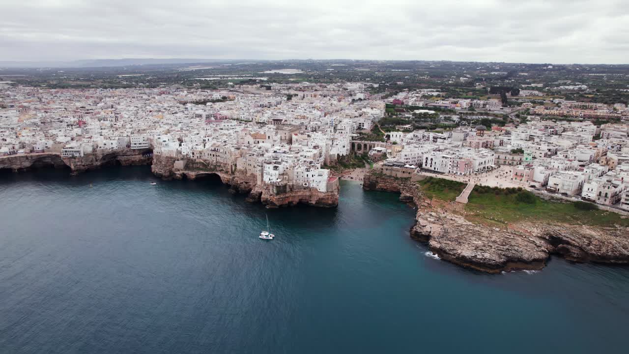 Aerial view of Polignano old town on rocky adriatic sea coast, Puglia, Italy